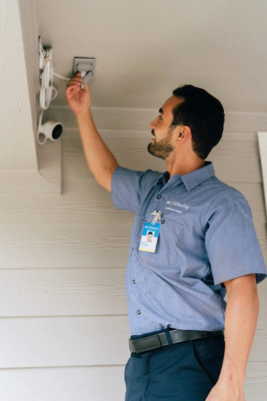 Mr. Electric of Wichita electrician installing motion sensor security lights.