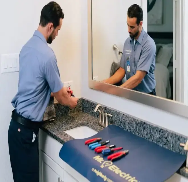 A Mr. Electric electrician inspecting an outlet in Gastonia, NC.