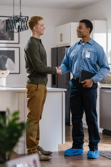 MRE electrician shaking hands with customer.