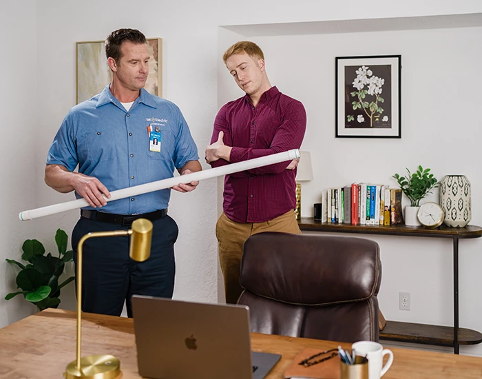 Mr. Electric electrician & customer in an office discussing commercial specialty lighting
