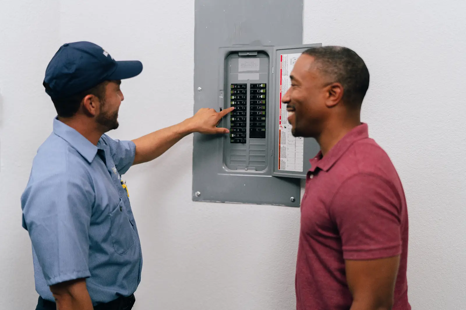 A Mr. Electric professional demonstrating how to reset a tripped circuit breaker